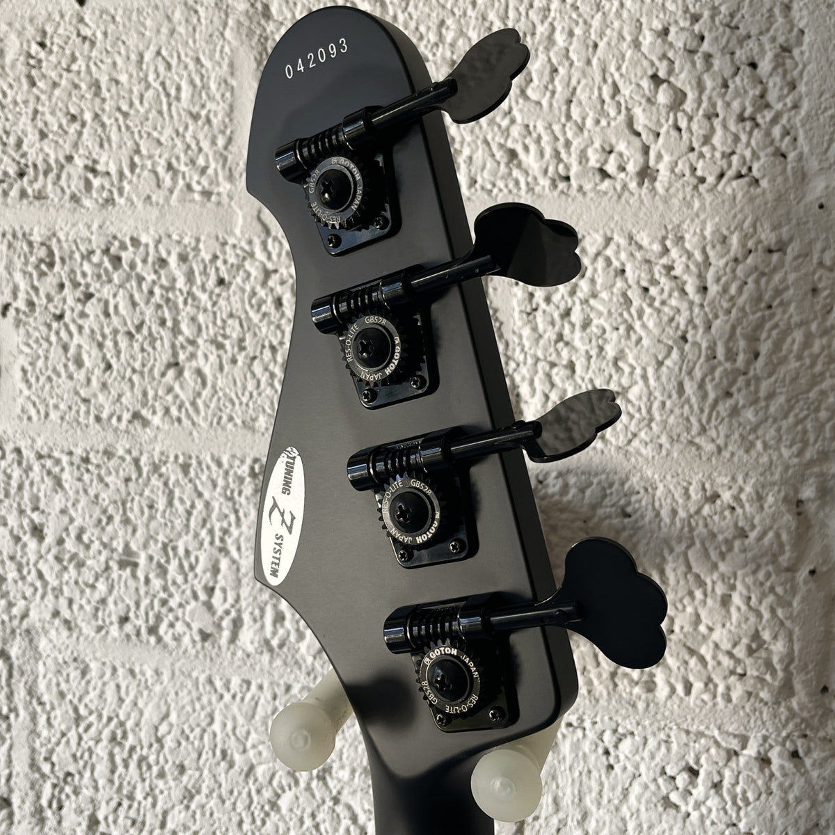 Atelier Z M#245 Custom 4-string bass in Matt Black with matching headstock and black hardware headstock back view