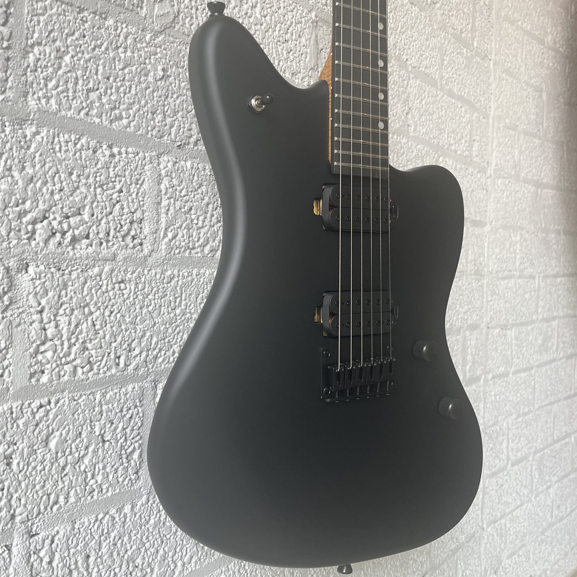 spira j400 mbk satin black electric guitar body closeup angled view left
